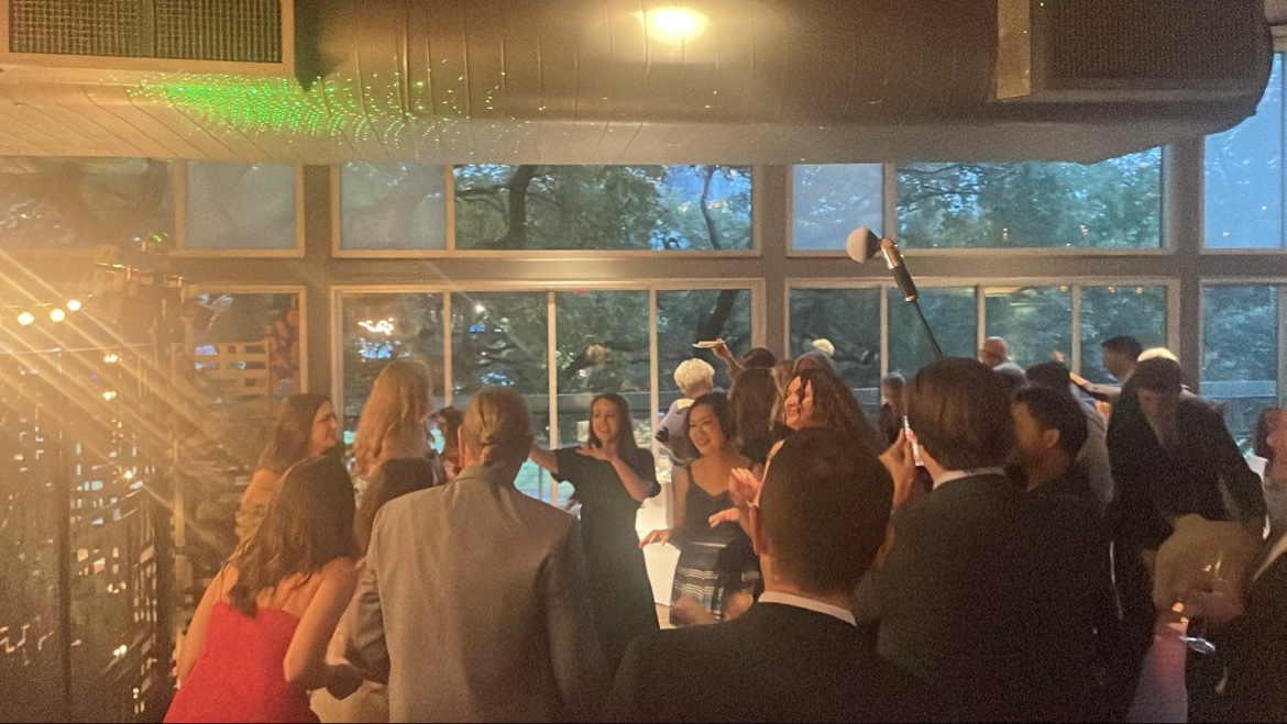 Indoor party crowd with green laser lights on the ceiling