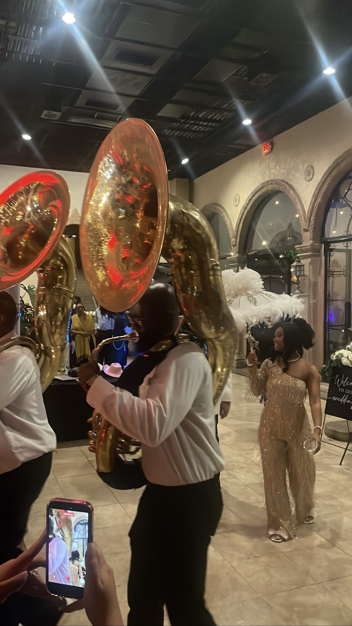 Brass band tuba player with the bride in a gold fringe dress