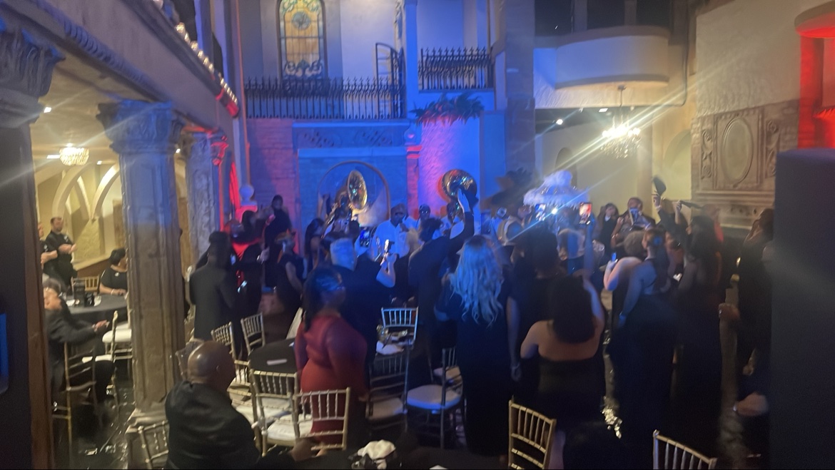 Second line wedding crowd under blue and red lights
